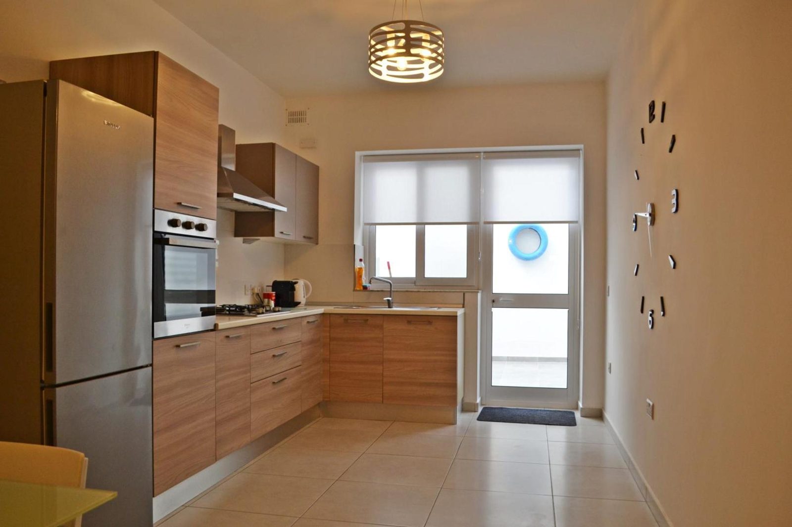 Kitchen with feature clock wall and door to the courtyard